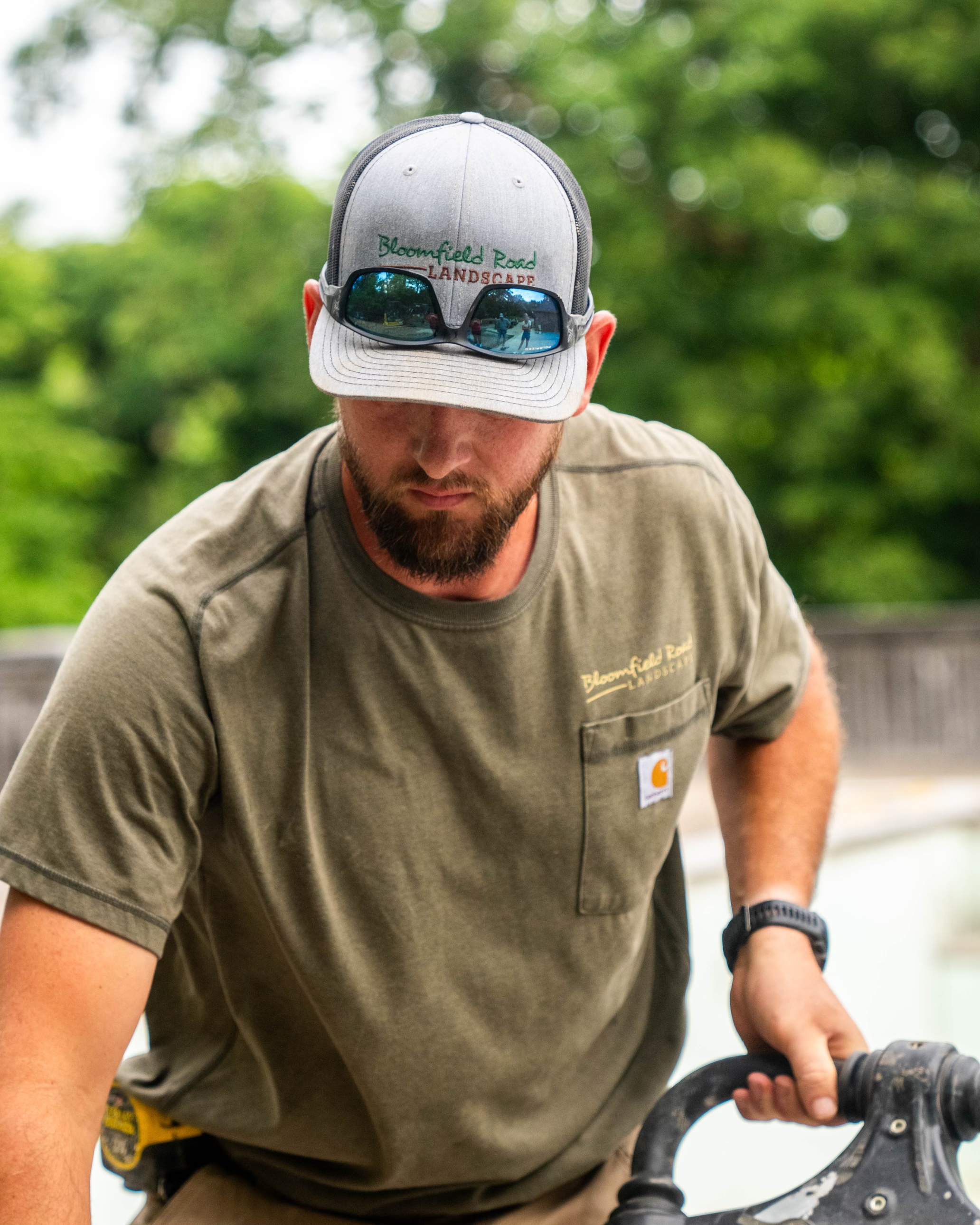 Load video: Landscaping crew wearing custom hats from Make My Cap